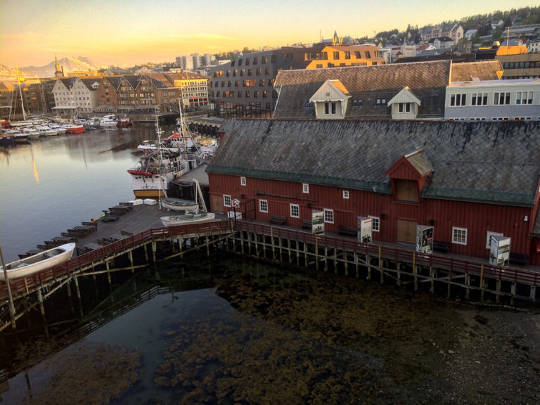 View across Tromsø’s Inner Harbour, where the midnight sun plays hide and seek among the buildings. © Knut Hansvold