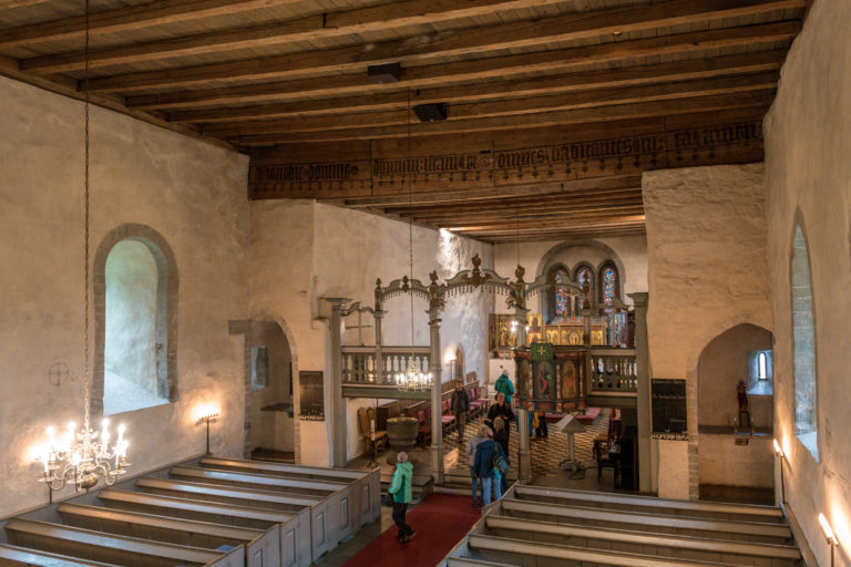 Interior from the church of Trondenes. The rood screen is from the end of the 18th. In the far eastern end, there are three Gothic triptychs from around 1500 © Dag Roland