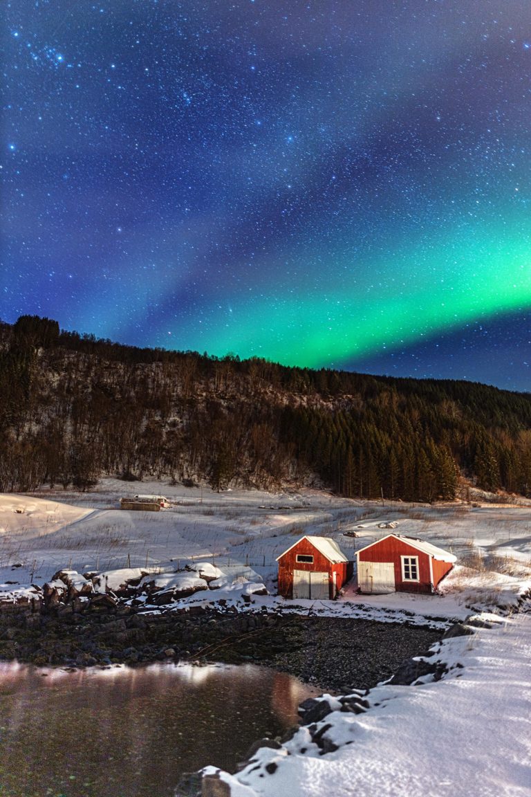 Northern Lights over the boat houses at Dyrøy © Dyrøy Holiday