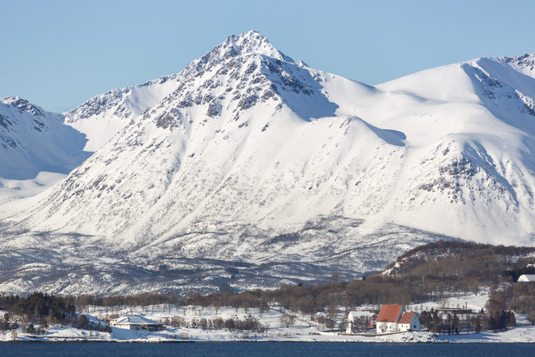 The point of Trondenes, the old church, the Historical Centre and the Grytøya Island peaks © Harriet S. Olsen/Sør-Troms Museum