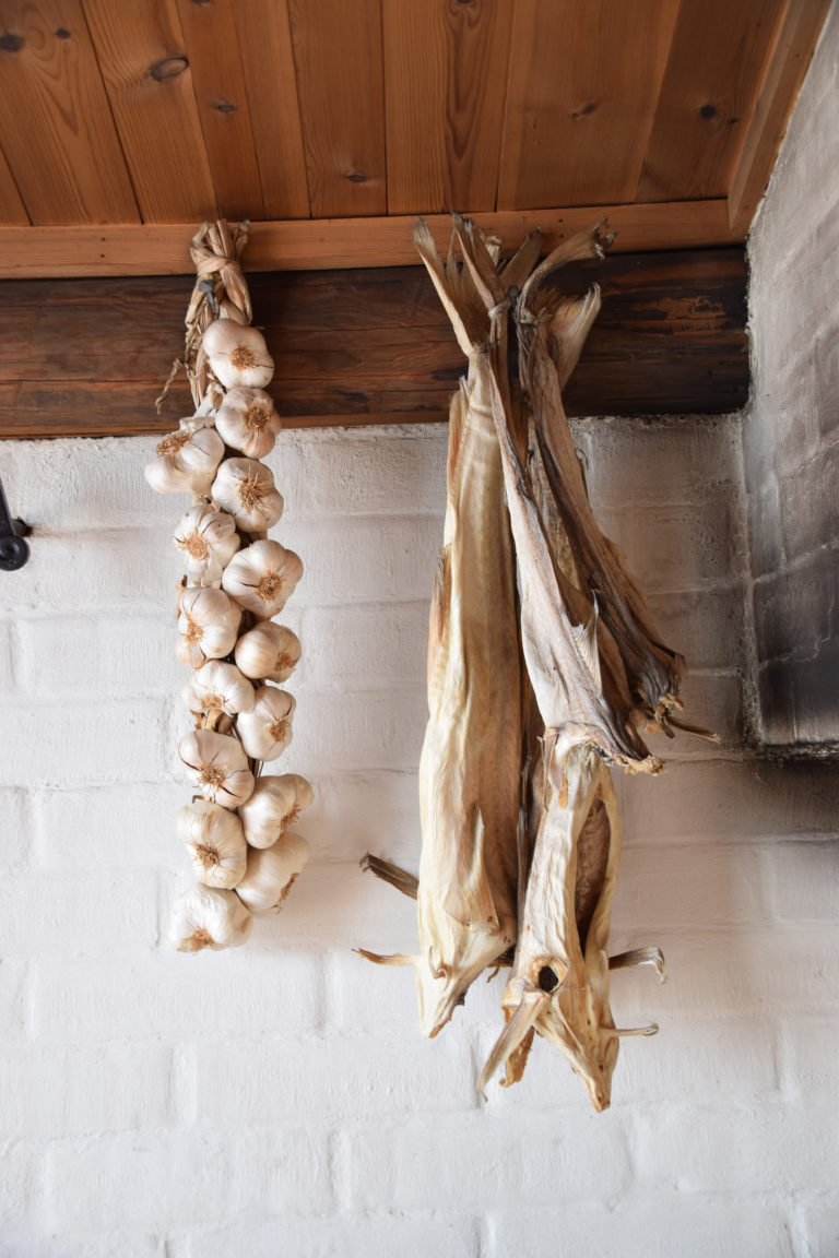 Stockfish and garlic hanging ready for cooking at Holmen in Lofoten. Photo: Mari Bareksten